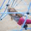 Girl climbing on Powerclimber climbing net at playground.