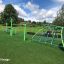 Playground with Rhombus Net and other climbing structures under a blue sky.