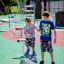 Children playing on a Surf Board playground equipment.