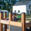 Child playing on Small Ship Nature playground structure.