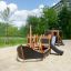 Small Ship Nature wooden playground ship with slide on sandy play area.