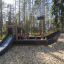 Small Ship Nature playground equipment for children in a forest setting.
