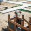 Wooden Small Ship Nature playground equipment in sandbox area.