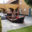 Small Ship Nature wooden playground structure in a courtyard