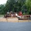 Small Ship Nature playground structure with slides and climbing elements in a park setting