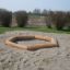 Sandbox with bark in a park area