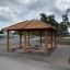 Wooden outdoor fireplace shelter Firehouse with benches and roof