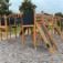 Wooden Searobber Castle with slide and climbing frames on a playground.