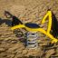Yacht Swing rocking playground toy on a sandy surface.