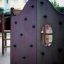 King-Kong Nature castle with slide in a playground, featuring a climbing wall.