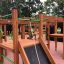 Wooden King-Kong Nature II castle with slide and climbing features.