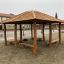 Wooden Firehouse playground structure at sandy school yard.