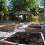 Firehouse wooden sandbox play area in a sunny outdoor setting