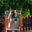 Tritowers Nature castle with slide wooden playground structure with child climbing stairs