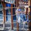 Child climbing on Tritowers Nature castle with slide featuring wooden structure and rope net.