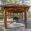 Wooden Long Firehouse shelter in a forested area.
