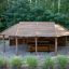 Long Firehouse wooden outdoor gazebo with picnic table in forest setting
