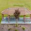 Long Firehouse wooden playground climbing structure with rope ladder and slide