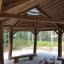 Wooden outdoor gazebo with tricycle under Long Firehouse.