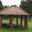 Wooden Long Firehouse gazebo in a park.