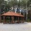 Outdoor wooden shelter with benches named Long Firehouse.