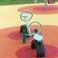 Seesaw playground equipment with tire bases on a colorful surface.