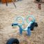 SeeSaw playground equipment on a sandy surface with tires for support.