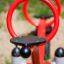Red SeeSaw playground equipment with circular handles.