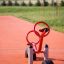 Red SeeSaw playground equipment on outdoor rubber matting.