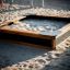 Wooden Sandbox Nature in a playground filled with sand