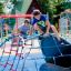 Children playing on Mini Climber steel structure in a playground.