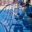 Children playing on Mini Climber steel structure in a playground.