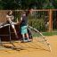 Children playing on a Mini Climber steel structure at a playground.
