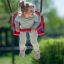 Child enjoying a Baby Double Swing outdoors