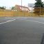 Outdoor basketball court with fencing and hoop in Santiago Bernabeu sports complex.