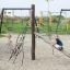 Kilimanjaro steel structure playground with children playing on climbing frame and slide.