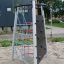 Steel climbing structure with ropes and rock wall for playground.