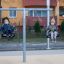 Youth Double Swing playground equipment with two children swinging outdoors