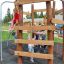 Children playing on Sherwood wooden playhouse.