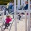 Children playing on a Sherwood wooden playhouse in a park.