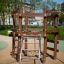 Sherwood wooden playhouse with climbing structure in a park.