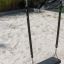 Silver Double Swing on a playground with a sandy surface