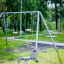 Silver Double Swing in a park with lush green surroundings