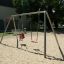 Silver Double Swing in a playground with a child in a seat swing and a regular swing
