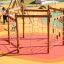 Yellowstone wooden playhouse with climbing net at playground