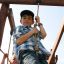 Children playing on Yellowstone wooden playhouse.