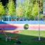 Seesaw playground equipment in a modern park setting with colorful background.