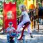Children playing on a Seesaw in a colorful playground.