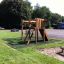 Serengeti wooden playhouse in outdoor playground setting.