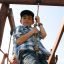 Children playing on the Serengeti wooden playhouse.